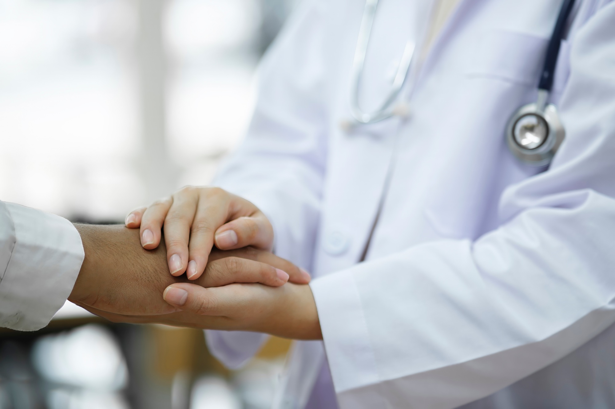 Kind doctor offering a loving gesture to a sick person during a health crisis.